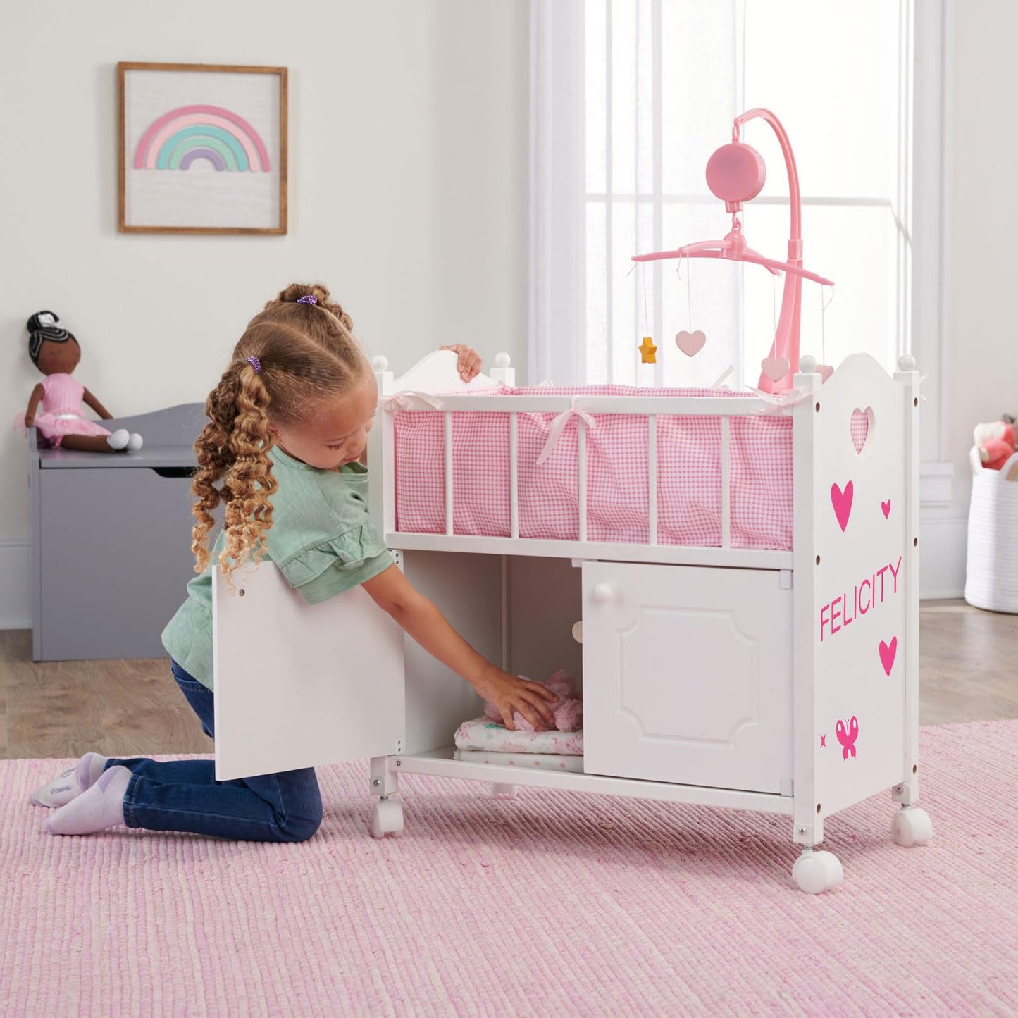 Badger Basket Wooden Toy Doll Bed with Storage, Mobile, and Bedding to Pretend and Play - Includes Wheels and Free Personalization Kit - White with Pink Gingham Fabric